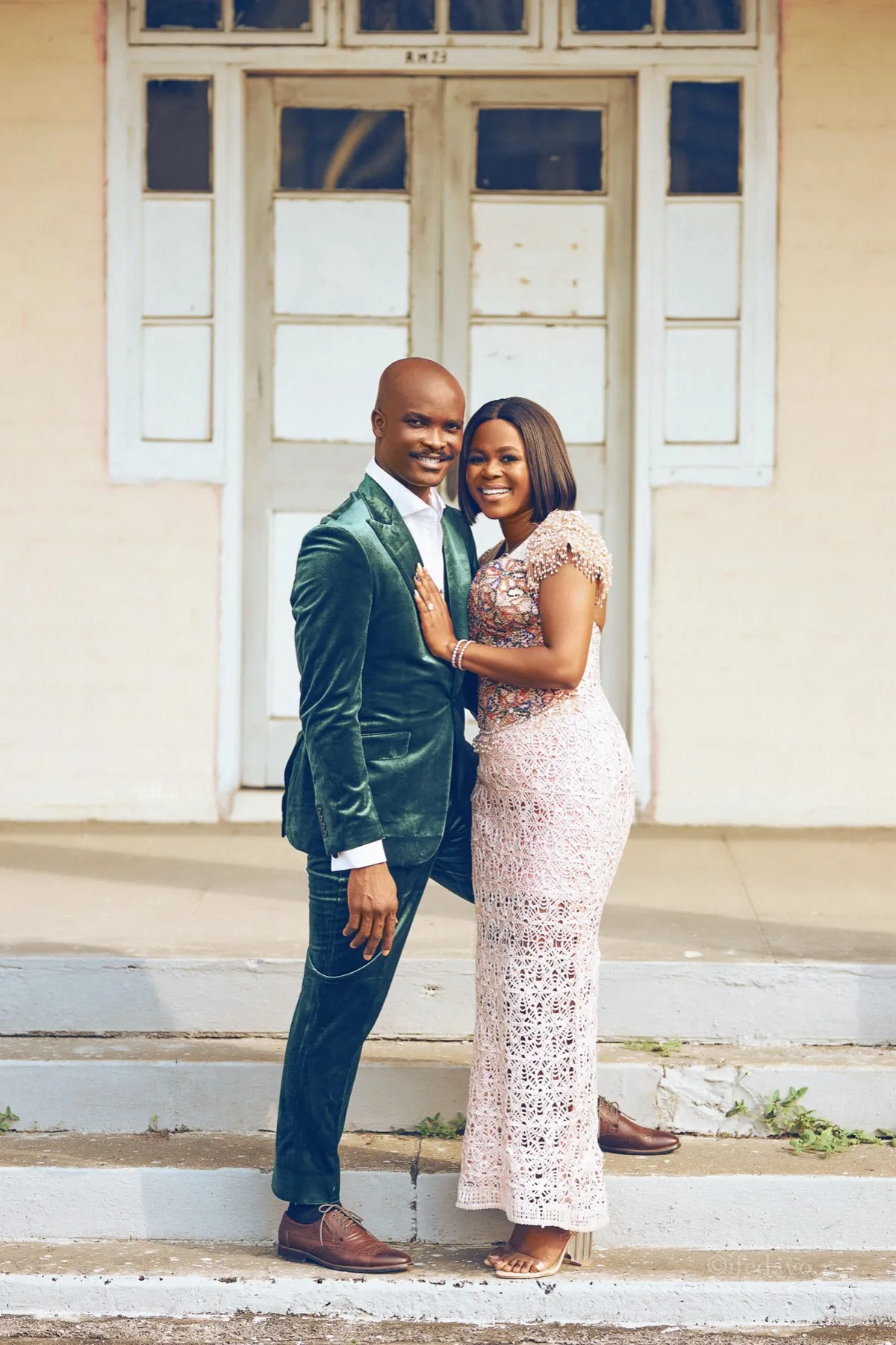 The couple at a white colonial doorway
