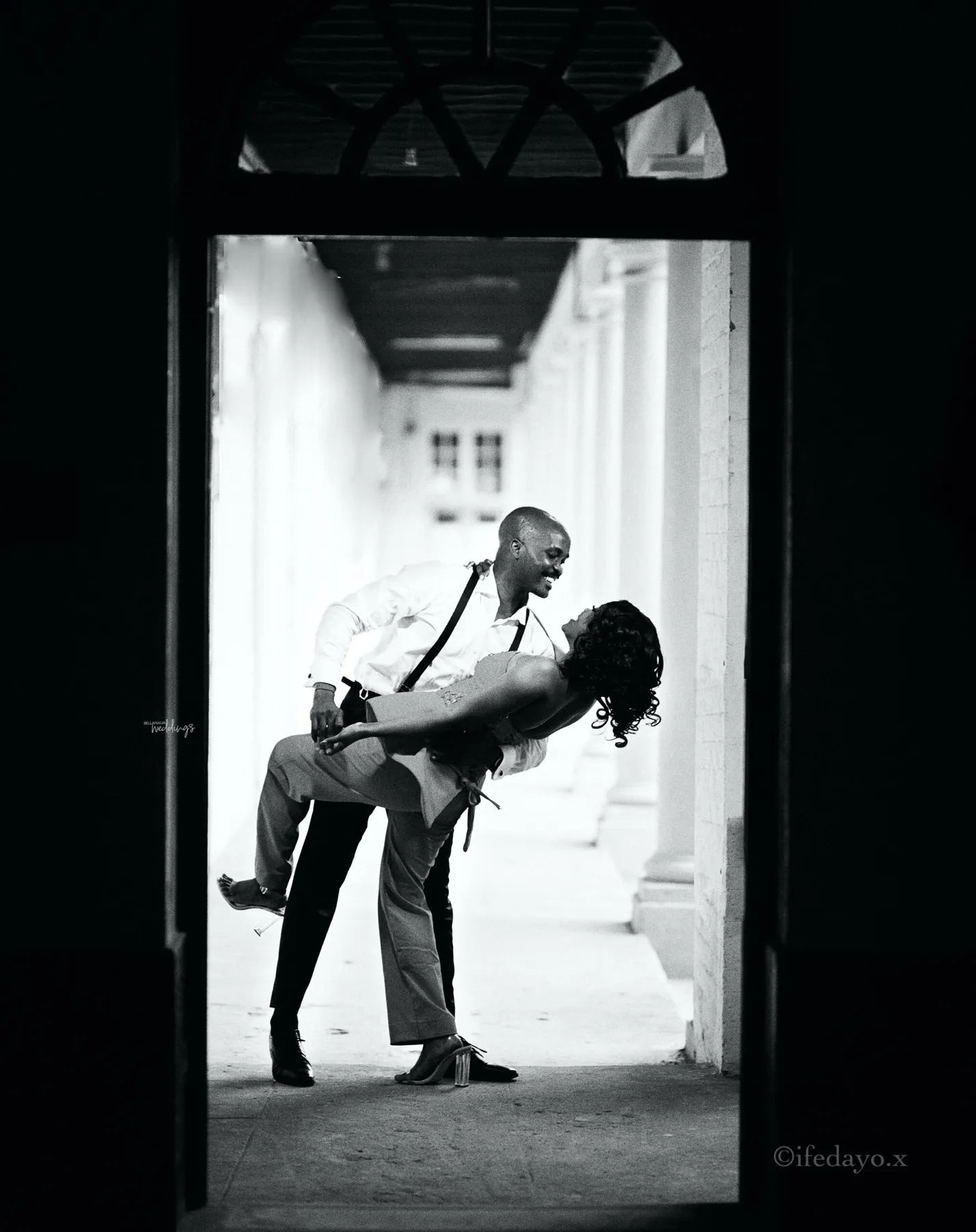 The couple laughing in a corridor