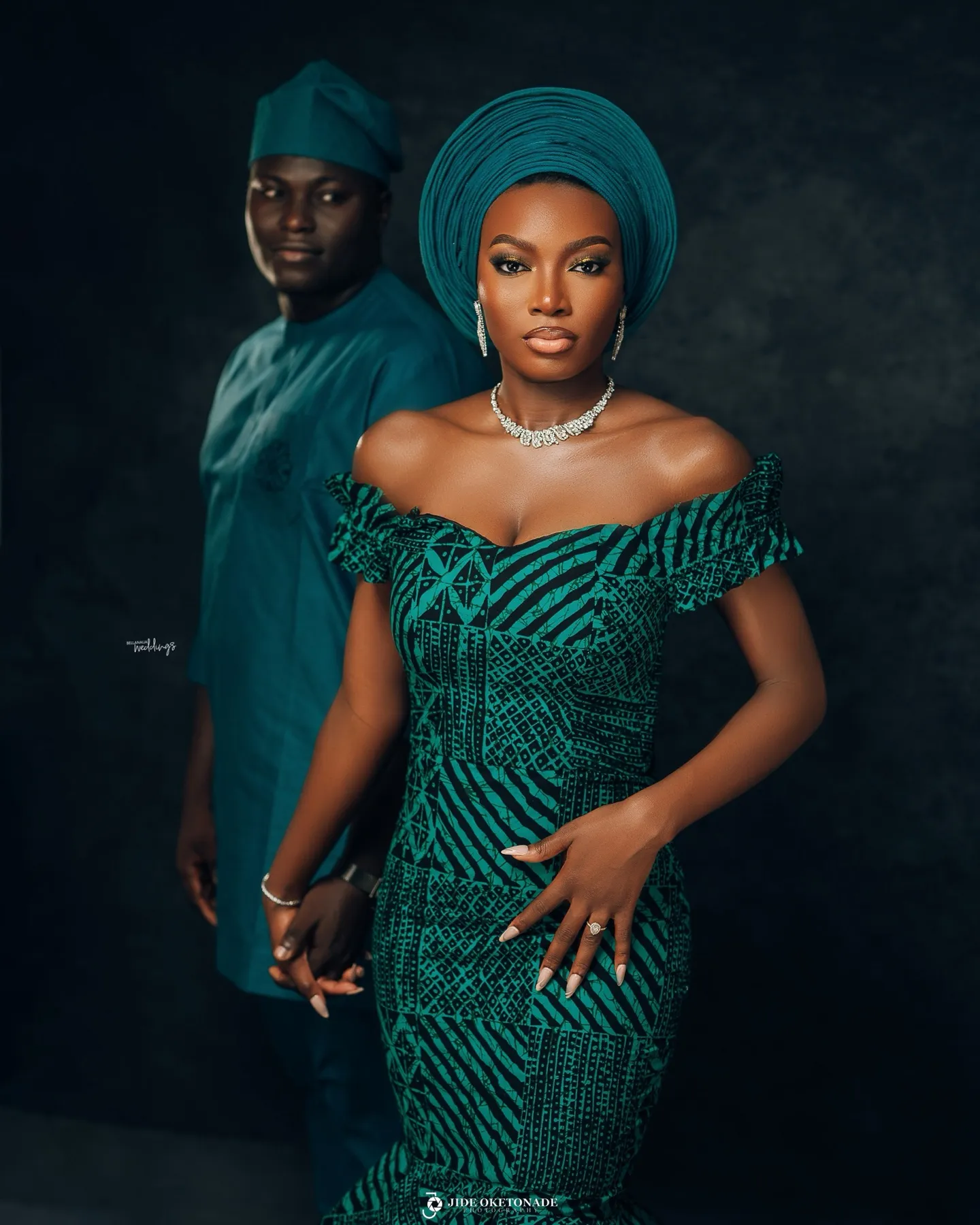 Esther in a teal gele and mermaid gown