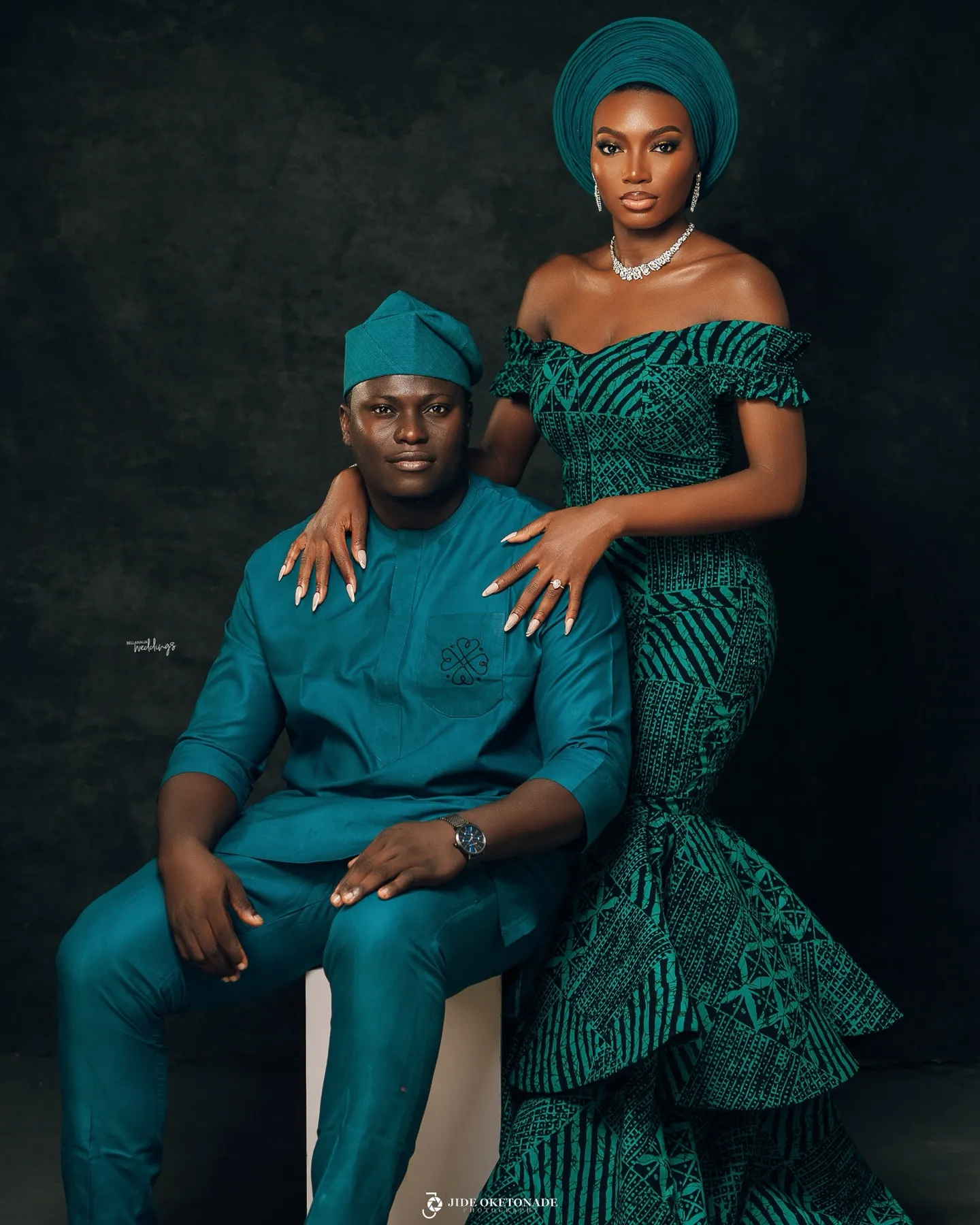 Deji seated with Esther standing beside him in teal