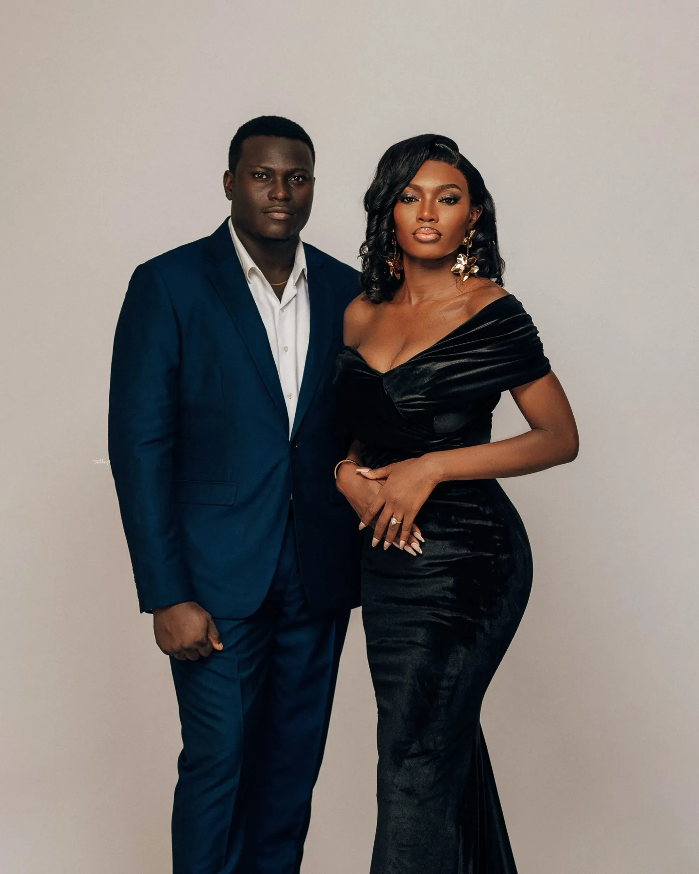 The couple standing together in black