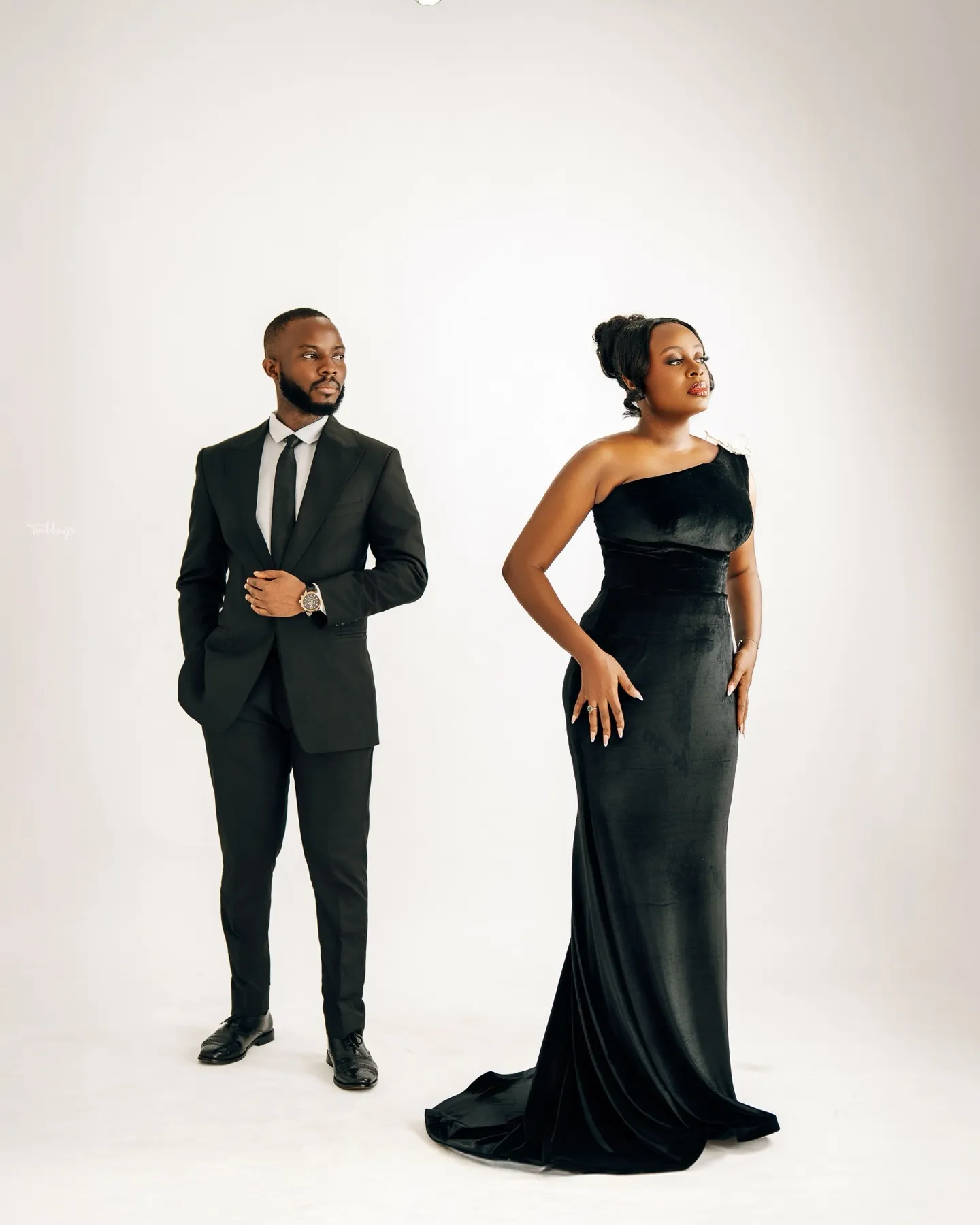 Hilda and Abraham standing in black on a white studio set
