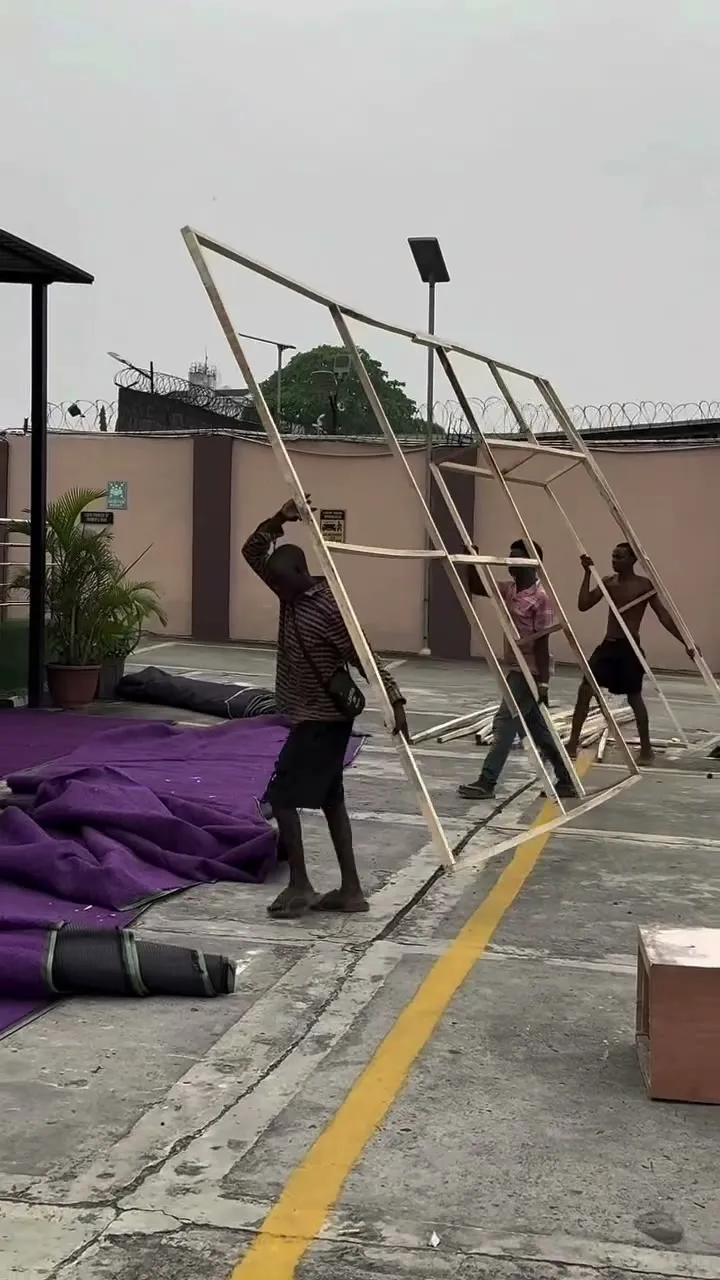 The crew rolling out purple carpet before the build