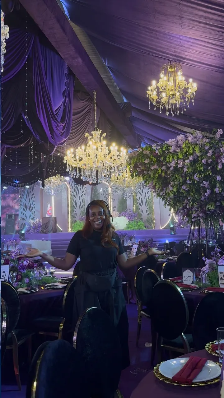 A Hills Concept coordinator with a headset in a finished purple hall