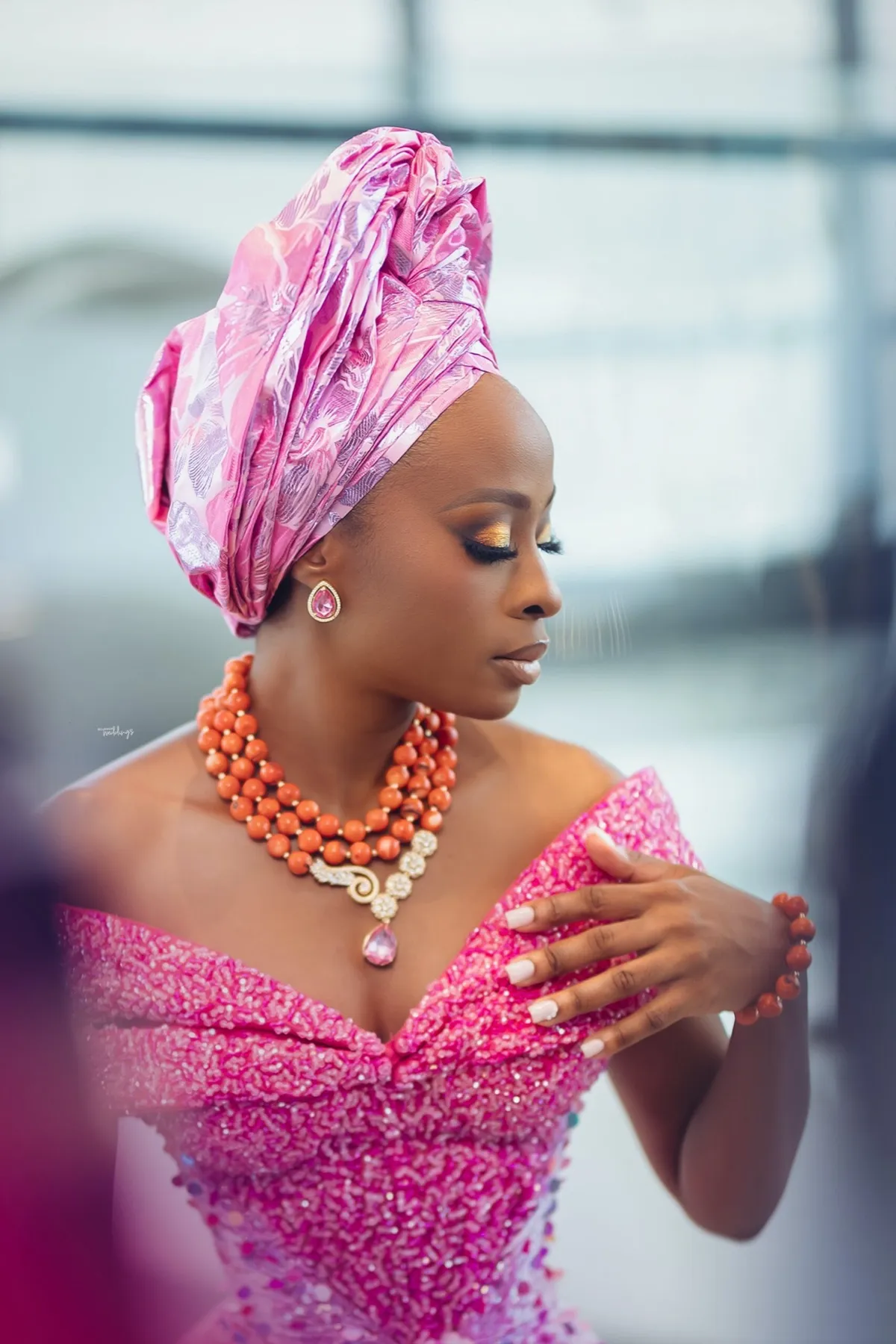 Lade in a pink gele and coral beads