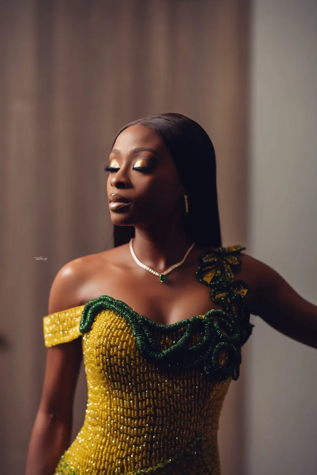 Lade in a yellow and green beaded gown